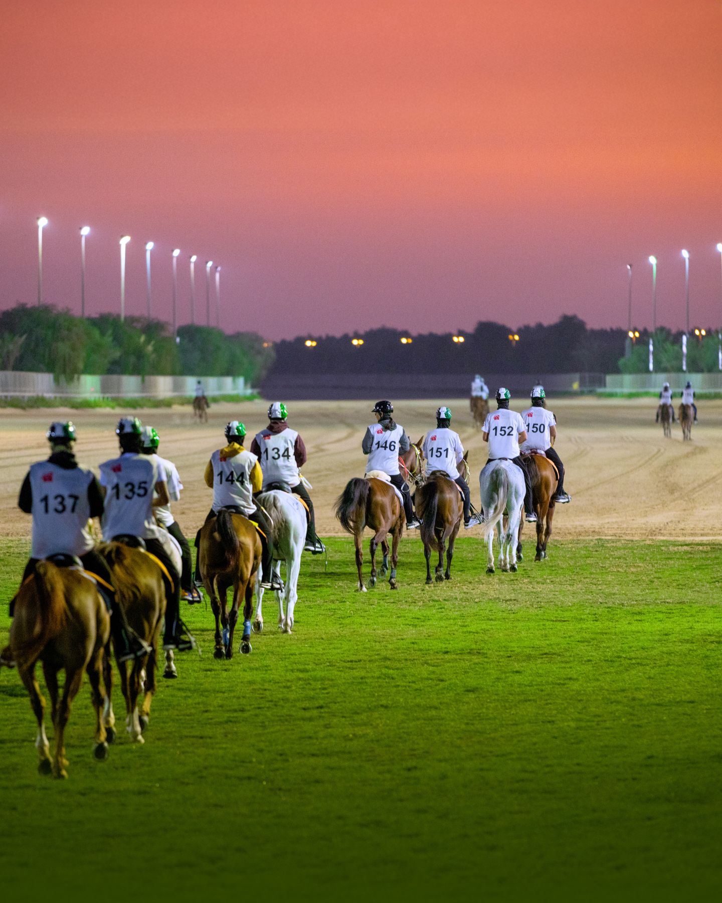 Riders under floodlights